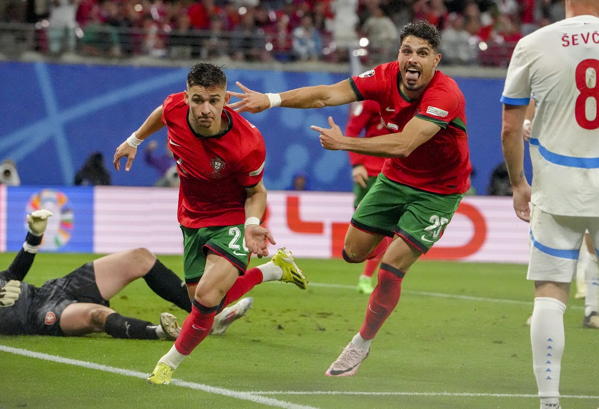 Portugal's Francisco Conceicao, centre, celebrates his side's second goal during a Group F match between Portugal and Czech Republic at the Euro 2024 soccer tournament in Leipzig, Germany, Tuesday, June 18, 2024. (AP Photo/Sunday Alamba)