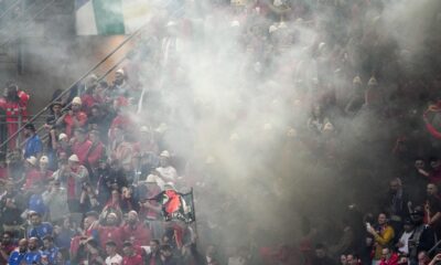 Smoke engulfs Albanian fans after Albania's Nedim Bajrami scored his side's opening goal during a Group B match between Italy and Albania at the Euro 2024 soccer tournament in Dortmund, Germany, Saturday, June 15, 2024. (AP Photo/Andreea Alexandru)