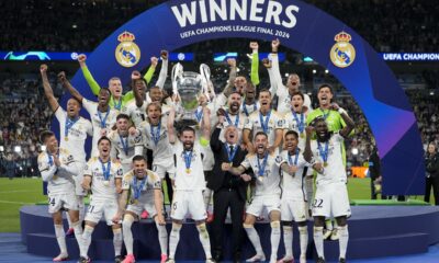 Real Madrid's players celebrate with the trophy after winning the Champions League final soccer match between Borussia Dortmund and Real Madrid at Wembley stadium in London, Saturday, June 1, 2024. (AP Photo/Kirsty Wigglesworth)