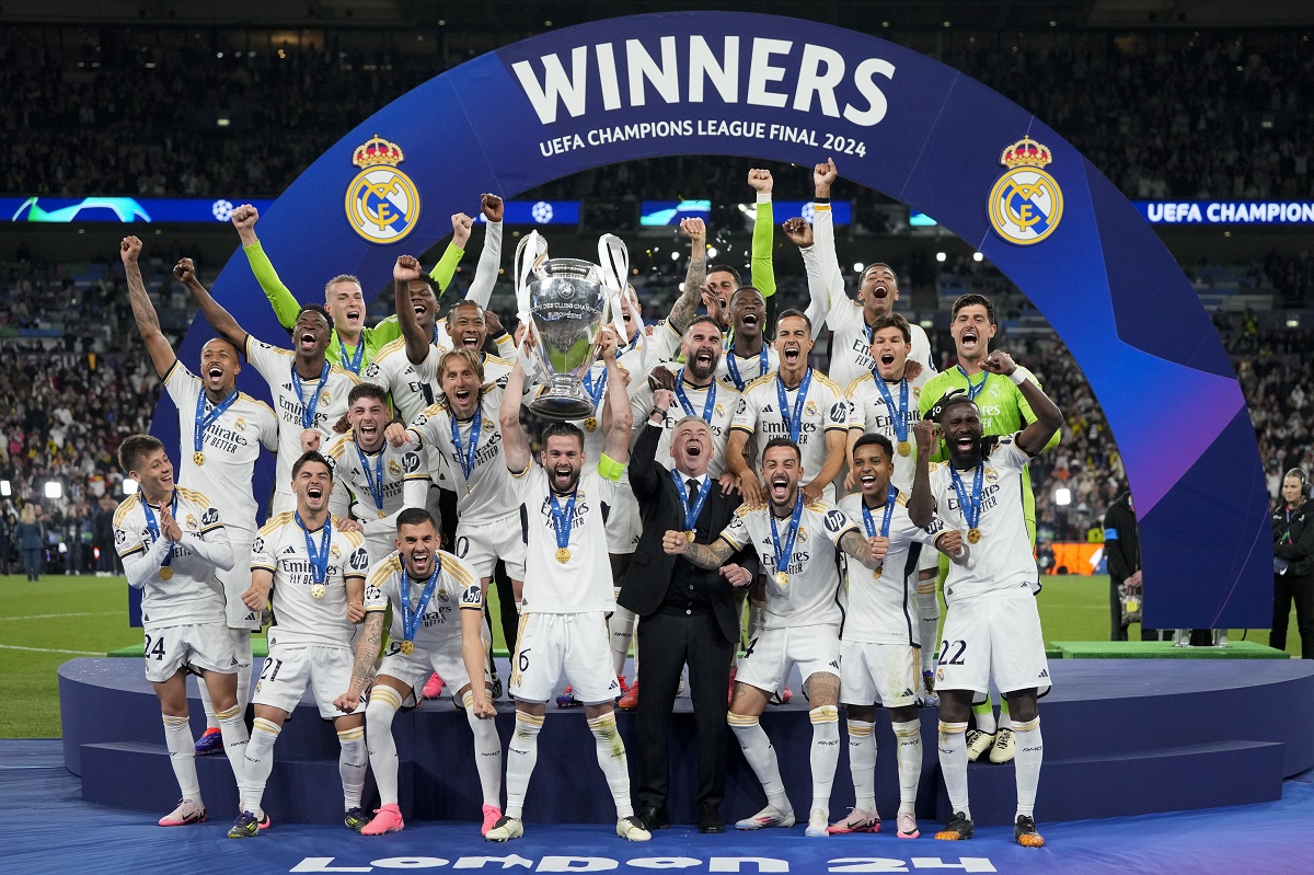 Real Madrid's players celebrate with the trophy after winning the Champions League final soccer match between Borussia Dortmund and Real Madrid at Wembley stadium in London, Saturday, June 1, 2024. (AP Photo/Kirsty Wigglesworth)