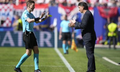 Croatia's head coach Zlatko Dalic, right, talks to French referee Francois Letexier during a Group B match between Croatia and Albania at the Euro 2024 soccer tournament in Hamburg, Germany, Wednesday, June 19, 2024. The match ended in a 2-2 draw. (AP Photo/Ebrahim Noroozi)