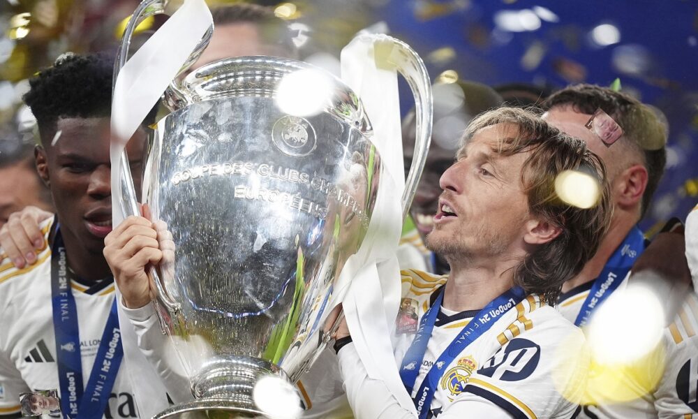 Real Madrid's Luka Modric celebrates with the trophy after winning the Champions League final soccer match between Borussia Dortmund and Real Madrid at Wembley stadium in London, Saturday, June 1, 2024. (Mike Egerton/PA via AP)