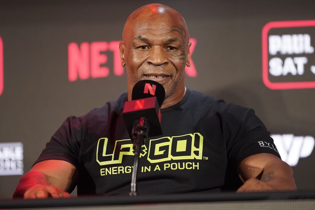 FILE - Mike Tyson speaks during a news conference promoting his upcoming boxing bout against Jake Paul, May 16, 2024, in Arlington, Texas. Tyson was recovering Monday, May 27, after suffering a medical emergency a day earlier during a flight from Miami to Los Angeles, his representatives said. The 58-year-old boxing legend “became nauseous and dizzy due to an ulcer flare up 30 minutes before landing” his publicist's office said in a statement. (AP Photo/Sam Hodde, File)