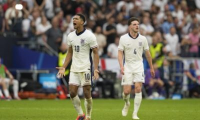 England's Jude Bellingham, left, celebrates after scoring his side's opening goal during a round of sixteen match between England and Slovakia at the Euro 2024 soccer tournament in Gelsenkirchen, Germany, Sunday, June 30, 2024. (AP Photo/Antonio Calanni)