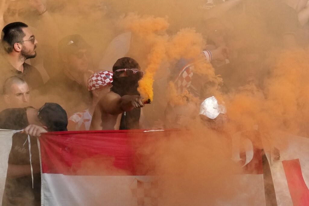 A Croatian fan holds a smoke flare during a Group B match between Spain and Croatia at the Euro 2024 soccer tournament in Berlin, Germany, Saturday, June 15, 2024. (AP Photo/Sunday Alamba)