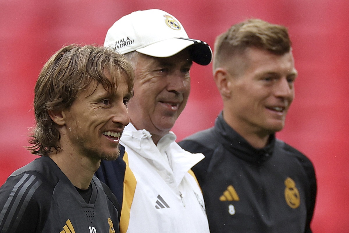 Real Madrid's Luka Modric, from left, Real Madrid's head coach Carlo Ancelotti and Real Madrid's Toni Kroos stand together during a training session ahead of the Champions League final soccer match between Borussia Dortmund and Real Madrid at Wembley Stadium in London, Friday, May 31, 2024.(AP Photo/Ian Walton)