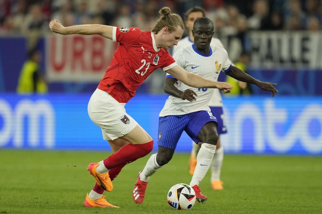 Austria's Patrick Wimmer challenges for the ball with N'Golo Kante of France during a Group D match between Austria and France at the Euro 2024 soccer tournament in Duesseldorf, Germany, Monday, June 17, 2024. (AP Photo/Andreea Alexandru)