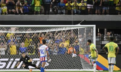 Brazil's Lucas Paqueta, second right, scores his side's 4th goal against Paraguay from the penalty spot during a Copa America Group D soccer match in Las Vegas, Friday, June 28, 2024. (AP Photo/David Becker)