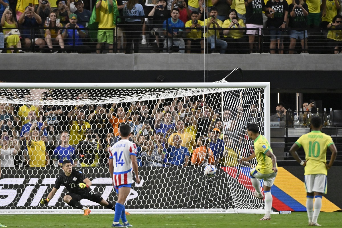 Brazil's Lucas Paqueta, second right, scores his side's 4th goal against Paraguay from the penalty spot during a Copa America Group D soccer match in Las Vegas, Friday, June 28, 2024. (AP Photo/David Becker)