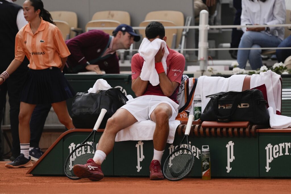 Serbia's Novak Djokovic dries his face during a changeover in his fourth round match of the French Open tennis tournament at the Roland Garros stadium in Paris, Monday, June 3, 2024. (AP Photo/Thibault Camus)