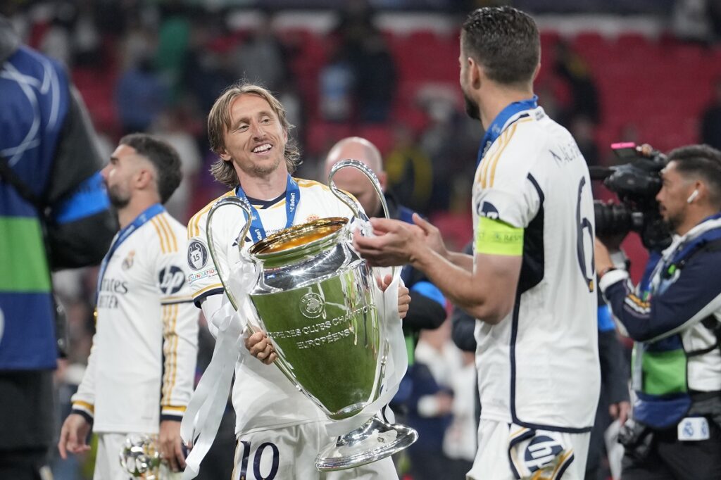 Real Madrid's Luka Modric, left, holds the trophy next to Nacho after winning the Champions League final soccer match between Borussia Dortmund and Real Madrid at Wembley stadium in London, Saturday, June 1, 2024. Real Madrid won 2-0. (AP Photo/Kin Cheung)