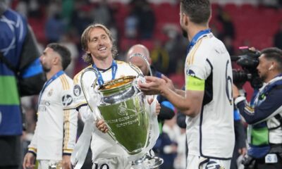 Real Madrid's Luka Modric, left, holds the trophy next to Nacho after winning the Champions League final soccer match between Borussia Dortmund and Real Madrid at Wembley stadium in London, Saturday, June 1, 2024. Real Madrid won 2-0. (AP Photo/Kin Cheung)