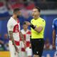 Referee Danny Makkelie, right, talks with Croatia's Marcelo Brozovic during a Group B match between Croatia and Italy at the Euro 2024 soccer tournament in Leipzig, Germany, Monday, June 24, 2024. (AP Photo/Ebrahim Noroozi)