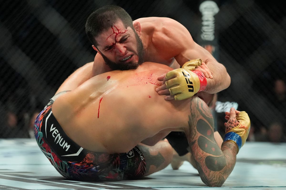 Russia's Islam Makhachev, above, grapples with Dustin Poirier during the fifth round of a lightweight title bout at the UFC 302 mixed martial arts event early Sunday, June 2, 2024, in Newark, N.J. Makhachev won the bout. (AP Photo/Frank Franklin II)