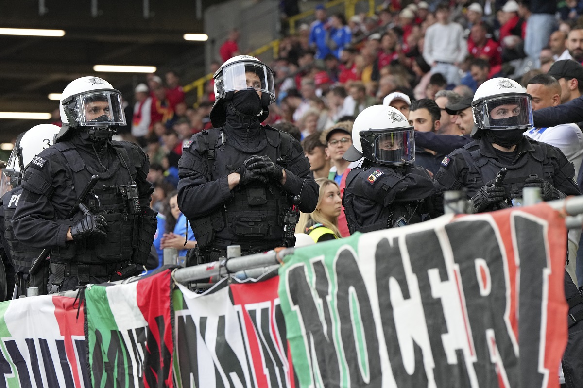 Police officers go into the crowd before the start of the Group B match between Italy and Albania at the Euro 2024 soccer tournament in Dortmund, Germany, Saturday, June 15, 2024. (AP Photo/Martin Meissner)