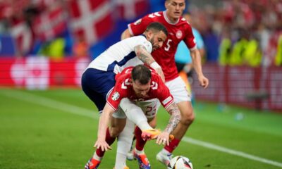 England's Kyle Walker, left, reaches for the ball around Denmark's Pierre-Emile Hojbjerg (23) during a Group C match between Denmark and England at the Euro 2024 soccer tournament in Frankfurt, Germany, Thursday, June 20, 2024. (AP Photo/Themba Hadebe)