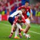 England's Kyle Walker, left, reaches for the ball around Denmark's Pierre-Emile Hojbjerg (23) during a Group C match between Denmark and England at the Euro 2024 soccer tournament in Frankfurt, Germany, Thursday, June 20, 2024. (AP Photo/Themba Hadebe)