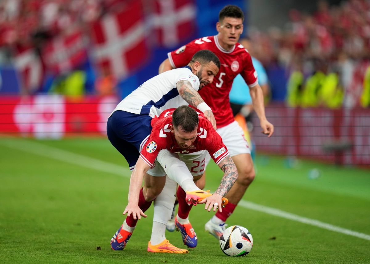 England's Kyle Walker, left, reaches for the ball around Denmark's Pierre-Emile Hojbjerg (23) during a Group C match between Denmark and England at the Euro 2024 soccer tournament in Frankfurt, Germany, Thursday, June 20, 2024. (AP Photo/Themba Hadebe)