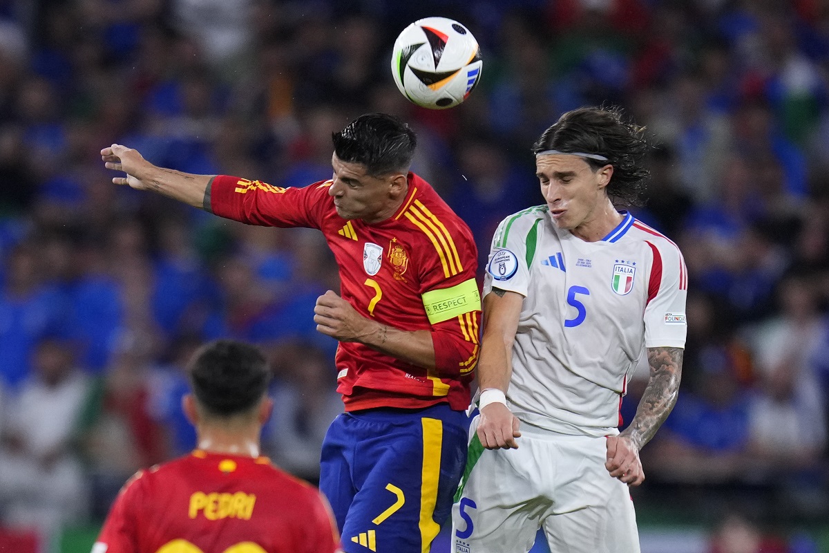 Spain's Alvaro Morata (7) and Italy's Riccardo Calafiori (5) battle for a header during a Group B match between Spain and Italy at the Euro 2024 soccer tournament in Gelsenkirchen, Germany, Thursday, June 20, 2024. (AP Photo/Manu Fernandez)