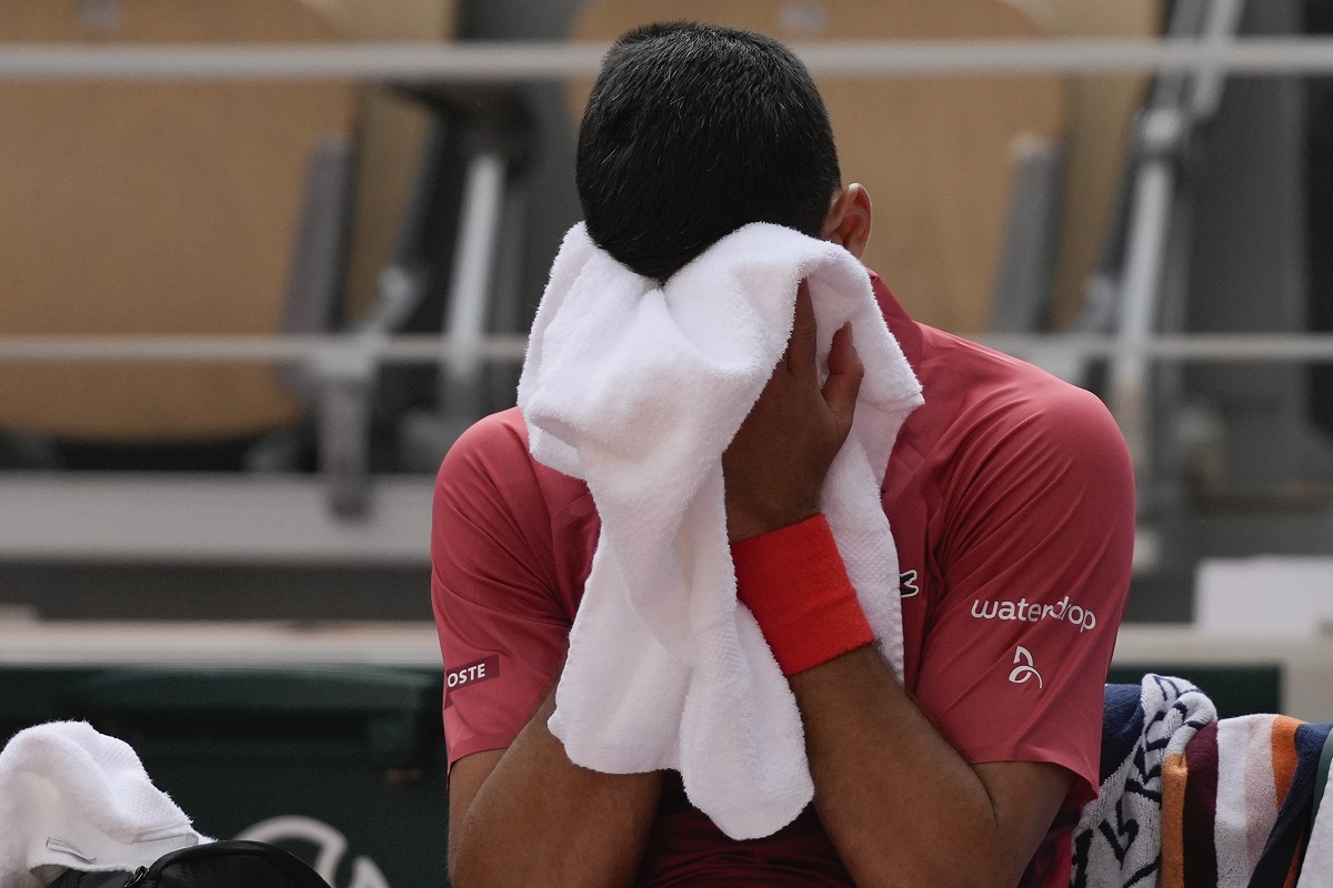Serbia's Novak Djokovic dries his face during a changeover in his fourth round match of the French Open tennis tournament at the Roland Garros stadium in Paris, Monday, June 3, 2024. (AP Photo/Thibault Camus)