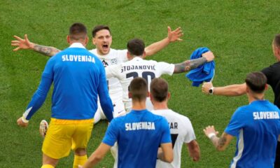 Slovenia's Erik Janza, on the ground, celebrates after scoring his side's first goal during a Group C match between Slovenia and Denmark at the Euro 2024 soccer tournament in Stuttgart, Germany, Sunday, June 16, 2024. (AP Photo/Ariel Schalit)