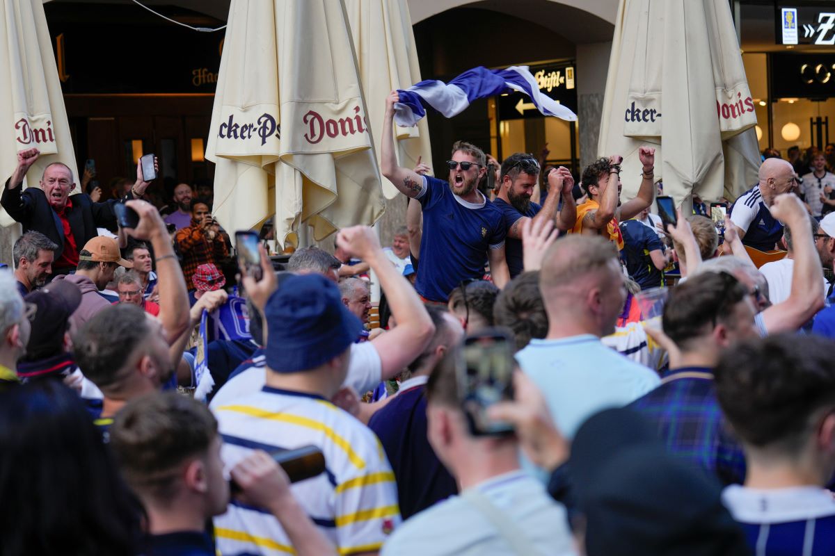 Scotland's soccer team fans cheer in 'Marienplatz' square next to the town hall in downtown Munich, Germany, Thursday, June 13, 2024. The Euro 2024 soccer tournament takes place in Germany from June 14 until July 14. (AP Photo/Ariel Schalit)