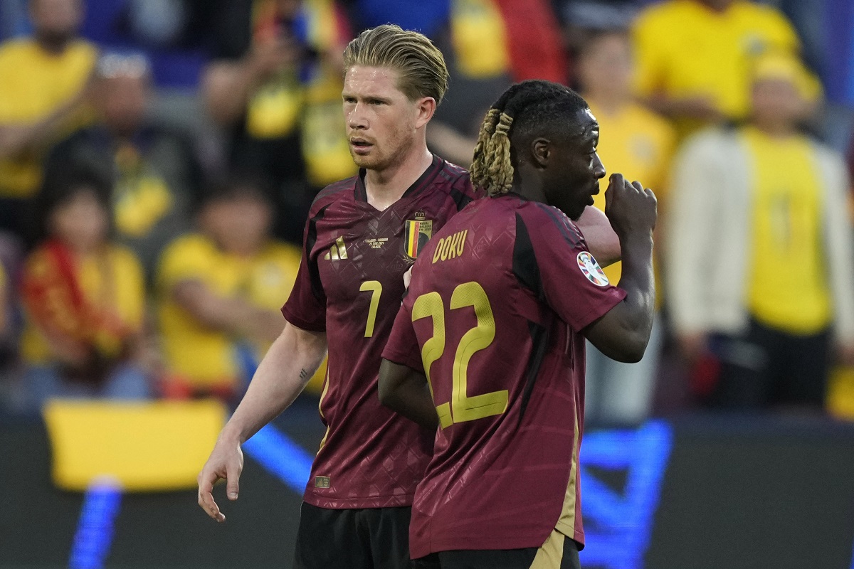 Belgium's Kevin De Bruyne, left, and Belgium's Jeremy Doku gather during a Group E match between Belgium and Romania at the Euro 2024 soccer tournament in Cologne, Germany, Saturday, June 22, 2024. (AP Photo/Martin Meissner)
