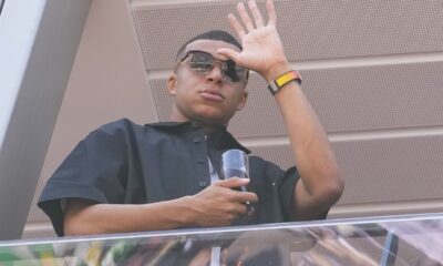 Kylian Mbappe waves from a terrace before the Formula One Monaco Grand Prix race at the Monaco racetrack, in Monaco, Sunday, May 26, 2024. (AP Photo/Luca Bruno)