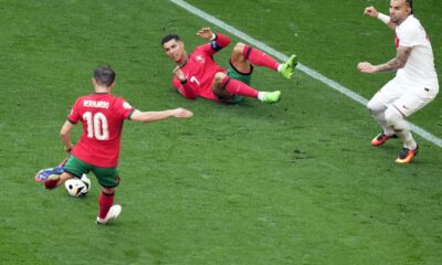 Portugal's Cristiano Ronaldo, on the ground, watches as teammate Bernardo Silva scores the opening goal during a Group F match between Turkey and Portugal at the Euro 2024 soccer tournament in Dortmund, Germany, Saturday, June 22, 2024. (AP Photo/Michael Probst)