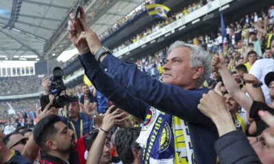 Portuguese soccer coach Jose Mourinho takes photographs with supporters during his official presentation as Turkish's Fenerbahce new coach at Sukru Saracoglu stadium in Istanbul, Turkey, Sunday, June 2, 2024. Mourinho has signed a two-year contract with Fenerbahce. (AP Photo)