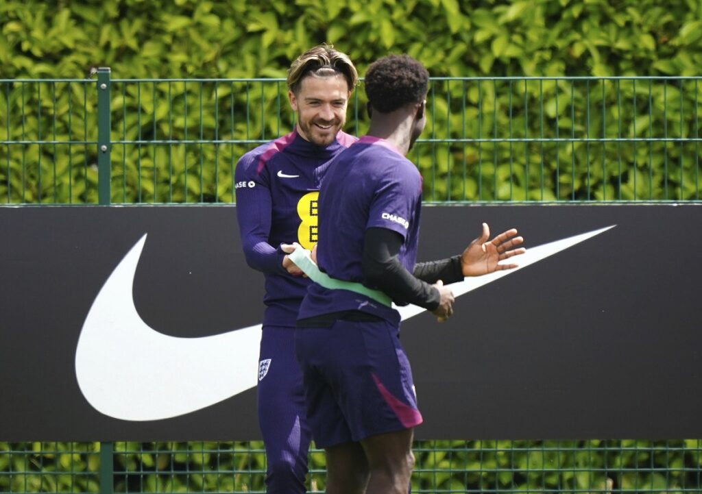 England's Bukayo Saka and Jack Grealish, left, during a training session at the Tottenham Hotspur Training Session, London, Thursday June 6, 2024. (Zac Goodwin/PA via AP)