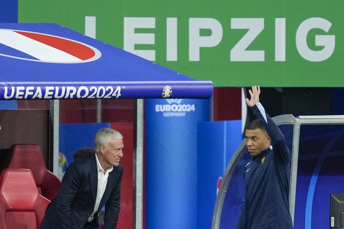 France head coach Didier Deschamps, left, looks Kylian Mbappe of France waves to supporters during a half-time of a Group D match between the Netherlands and France at the Euro 2024 soccer tournament in Leipzig, Germany, Friday, June 21, 2024. (AP Photo/Ariel Schalit)