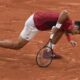 Serbia's Novak Djokovic slipped and fell during his fourth round match of the French Open tennis tournament against Argentina's Francisco Cerundolo at the Roland Garros stadium in Paris, Monday, June 3, 2024. (AP Photo/Christophe Ena)