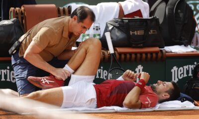 Serbia's Novak Djokovic receives medical assistance for his right knee during his fourth round match of the French Open tennis tournament against Argentina's Francisco Cerundolo at the Roland Garros stadium in Paris, Monday, June 3, 2024. (AP Photo/Jean-Francois Badias)
