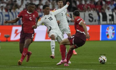 Switzerland's Manuel Akanji, left, challenges Germany's Jamal Musiala during a Group A match between Switzerland and Germany at the Euro 2024 soccer tournament in Frankfurt, Germany, Sunday, June 23, 2024. (AP Photo/Darko Vojinovic)