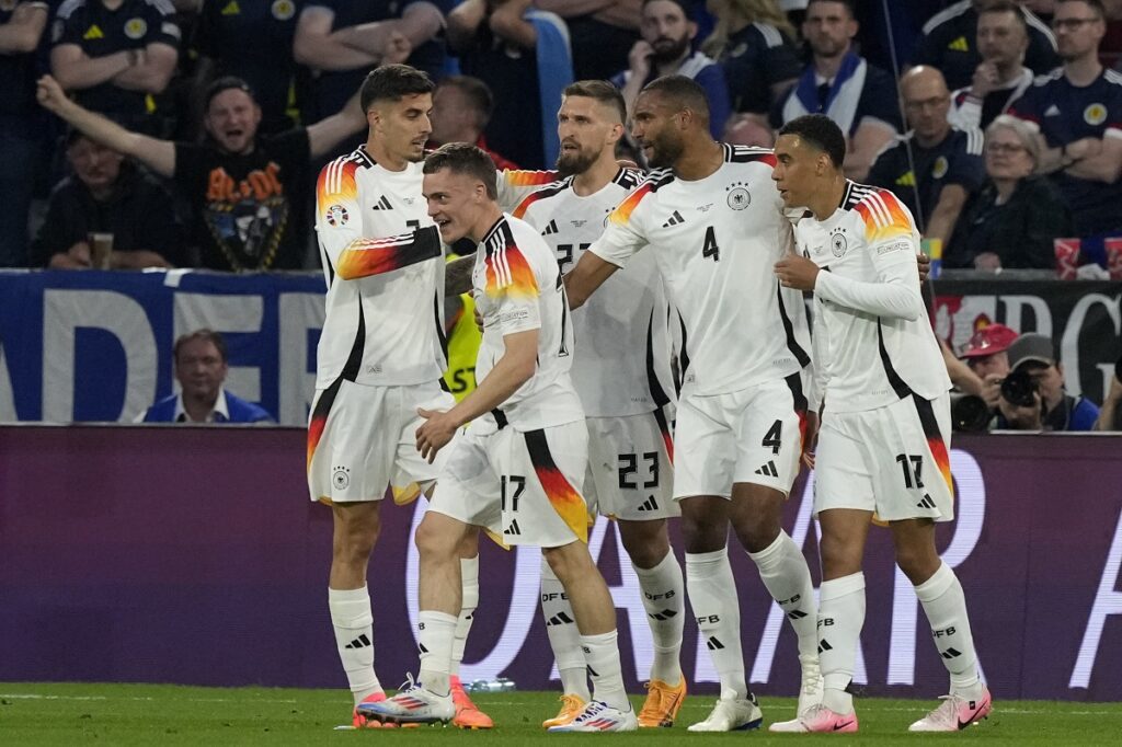 Germany's Florian Wirtz, 2nd from left, celebrates with his team after he scored the opening goal during a Group A match between Germany and Scotland at the Euro 2024 soccer tournament in Munich, Germany, Friday, June 14, 2024. (AP Photo/Frank Augstein)