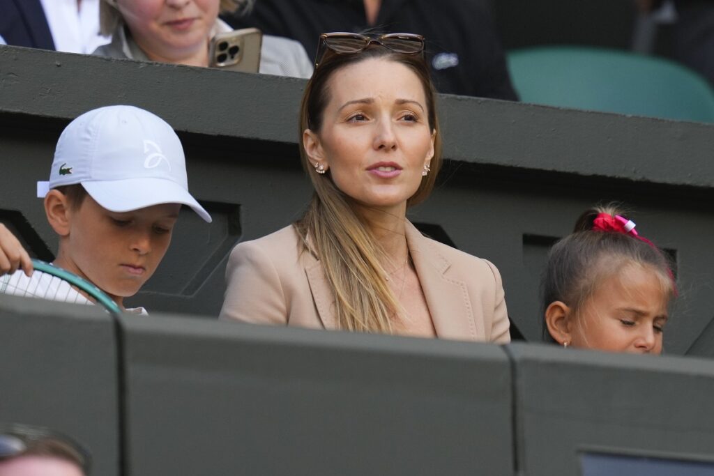 Jelena Djokovic and her children Stefan and Tara wait to watch the second round match between her husband, Serbia's Novak Djokovic and Britain's Jacob Fearnley on Centre Court at the Wimbledon tennis championships in London, Thursday, July 4, 2024. (AP Photo/Kirsty Wigglesworth)