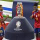 Spain's Lamine Yamal, left, and Nico Williams celebrate at the podium during the final match against England at the Euro 2024 soccer tournament in Berlin, Germany, Sunday, July 14, 2024. Spain won the game 2-1. (AP Photo/Thanassis Stavrakis)