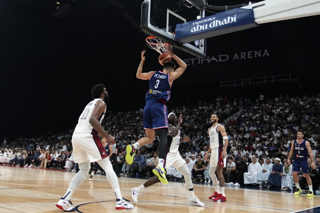 Serbia's Filip Petrusev scores during an exhibition basketball match between Serbia and the United States at the USA Basketball Showcase, ahead of the 2024 Paris Olympic basketball tournament, in Abu Dhabi, United Arab Emirates, Wednesday, July 17, 2024. (AP Photo/Altaf Qadri)