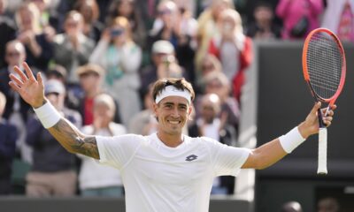 Francisco Comesana of Argentina celebrates after defeating Andrey Rublev of Russia in their first round match at the Wimbledon tennis championships in London, Tuesday, July 2, 2024. (AP Photo/Alberto Pezzali)