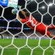 Argentina's goalkeeper Emiliano Martinez block the shot of Ecuador's Angel Mena during a penalty shootout in a Copa America quarterfinal soccer match in Houston, Thursday, July 4, 2024. (AP Photo/Julio Cortez)