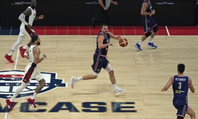 Serbia's Nikola Jokic, center, collects a pass during an exhibition basketball match between Serbia and the United States at the USA Basketball Showcase, ahead of the 2024 Paris Olympic basketball tournament, in Abu Dhabi, United Arab Emirates, Wednesday, July 17, 2024. (AP Photo/Altaf Qadri)