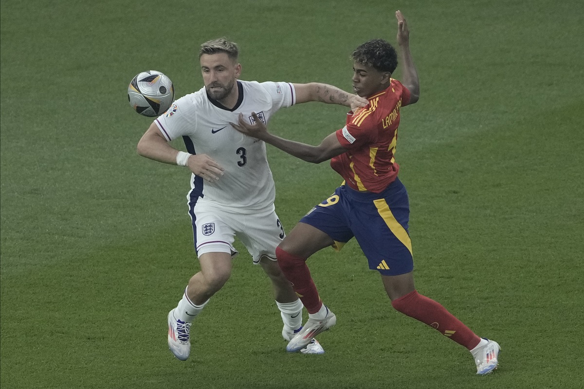 Spain's Lamine Yamal, right, and England's Luke Shaw battle for the ball during the final match at the Euro 2024 soccer tournament in Berlin, Germany, Sunday, July 14, 2024. (AP Photo/Thanassis Stavrakis)