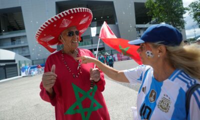 Celia Vicente, 68, of Argentina, right, talks with a supporter of Morocco, before the men's Group B soccer match between Argentina and Morocco at the Geoffroy-Guichard Stadium during the 2024 Summer Olympics, Wednesday, July 24, 2024, in Saint-Etienne, France. (AP Photo/Silvia Izquierdo)