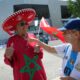 Celia Vicente, 68, of Argentina, right, talks with a supporter of Morocco, before the men's Group B soccer match between Argentina and Morocco at the Geoffroy-Guichard Stadium during the 2024 Summer Olympics, Wednesday, July 24, 2024, in Saint-Etienne, France. (AP Photo/Silvia Izquierdo)