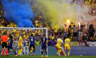 Romania supporters light flares and smoke bombs on the stands during a round of sixteen match between Romania and the Netherlands at the Euro 2024 soccer tournament in Munich, Germany, Tuesday, July 2, 2024. (AP Photo/Manu Fernandez)