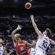 Puerto Rico's Jose Alvarado, center, launches a shot over Lithuania's Rokas Jokubaitis, right, during the final game of the FIBA Olympic qualifying tournament in San Juan, Puerto Rico, Sunday, July 7, 2024. (AP Photo/Alejandro Granadillo)