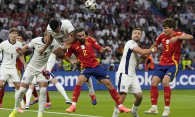 England's Jude Bellingham, top, jumps for the ball with Spain's Dani Carvajal during the final match between Spain and England at the Euro 2024 soccer tournament in Berlin, Germany, Sunday, July 14, 2024. (AP Photo/Frank Augstein)