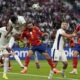 England's Jude Bellingham, top, jumps for the ball with Spain's Dani Carvajal during the final match between Spain and England at the Euro 2024 soccer tournament in Berlin, Germany, Sunday, July 14, 2024. (AP Photo/Frank Augstein)