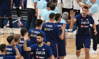 Serbia's Nikola Jokic, right, greets teammates as he enters the court to play an exhibition basketball match between Serbia and the United States at the USA Basketball Showcase, ahead of the 2024 Paris Olympic basketball tournament, in Abu Dhabi, United Arab Emirates, Wednesday, July 17, 2024. (AP Photo/Altaf Qadri)